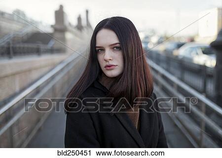 Serious Caucasian girl standing on footbridge View Large Photo Image Stock Image - Serious Caucasian girl standing on footbridge. Fotosearch
