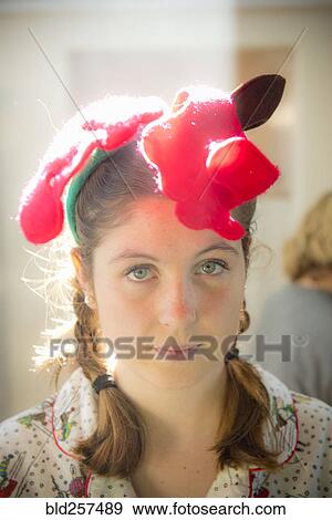 Serious Caucasian girl wearing Christmas decoration on head View Large Photo Image Stock Photo - Serious Caucasian girl wearing Christmas decoration on head. Fotosearch