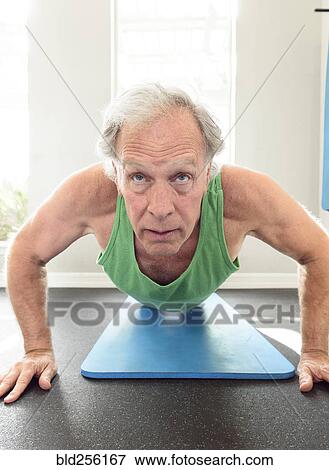 Serious Caucasian man doing push-ups View Large Photo Image Stock Photo - Serious Caucasian man doing push-ups. Fotosearch