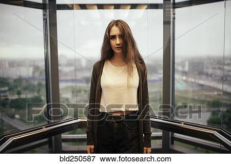 Serious Caucasian woman in glass elevator View Large Photo Image Stock Photo - Serious Caucasian woman in glass elevator. Fotosearch