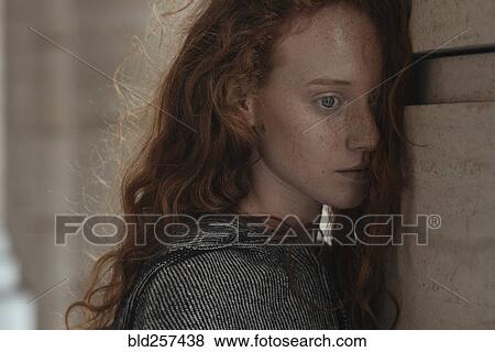 Serious Caucasian woman leaning face on pillar View Large Photo Image Stock Photo - Serious Caucasian woman leaning face on pillar. Fotosearch