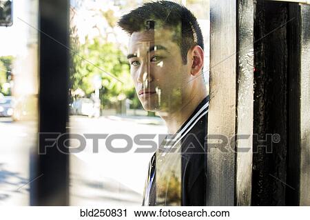Serious Chinese man behind window View Large Photo Image Stock Image - Serious Chinese man behind window. Fotosearch