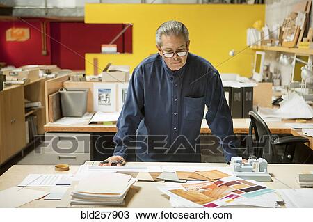 Serious Hispanic designer examining color swatches in office View Large Photo Image Stock Image - Serious Hispanic designer examining color swatches in office. Fotosearch