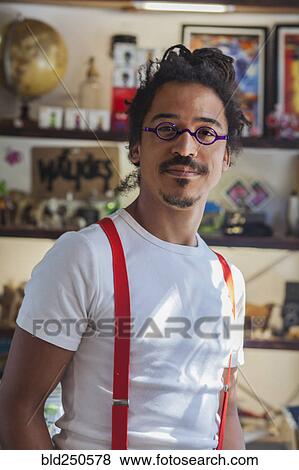 Serious mixed race man wearing suspenders View Large Photo Image Stock Photo - Serious mixed race man wearing suspenders. Fotosearch