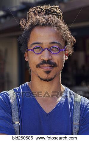 Serious mixed race man wearing suspenders View Large Photo Image Stock Photograph - Serious mixed race man wearing suspenders. Fotosearch