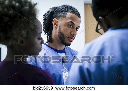 Stock Photo - Serious nurses talking. Fotosearch
