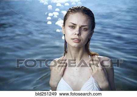 Serious woman wearing a bikini in ocean View Large Photo Image Stock Photo - Serious woman wearing a bikini in ocean. Fotosearch