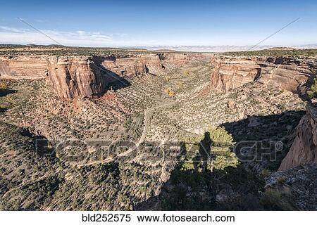 Stock Photography - Shadow of person admiring scenic view of canyon. Fotosearch
