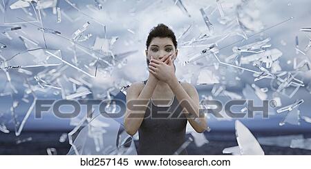 Shards of glass surrounding woman covering mouth with hands View Large Photo Image Stock Photography - Shards of glass surrounding woman covering mouth with hands. Fotosearch