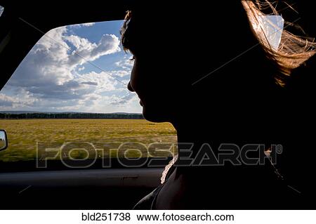 Silhouette of smiling woman passenger in car View Large Photo Image Stock Photo - Silhouette of smiling woman passenger in car. Fotosearch