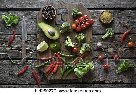 Sliced fruit and vegetables on cutting board View Large Photo Image Stock Image - Sliced fruit and vegetables on cutting board. Fotosearch