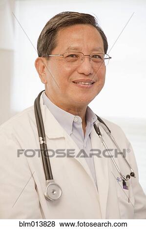 Stock Photo - Smiling Asian doctor. Fotosearch