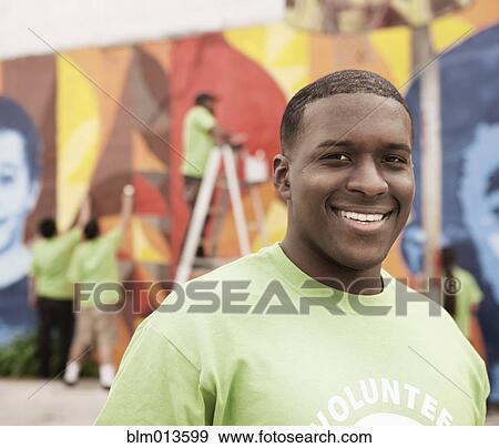 Smiling Black volunteer View Large Photo Image Stock Photo - Smiling Black volunteer. Fotosearch