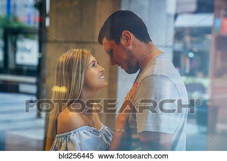 Smiling Caucasian couple behind window View Large Photo Image Stock Photography - Smiling Caucasian couple behind window. Fotosearch