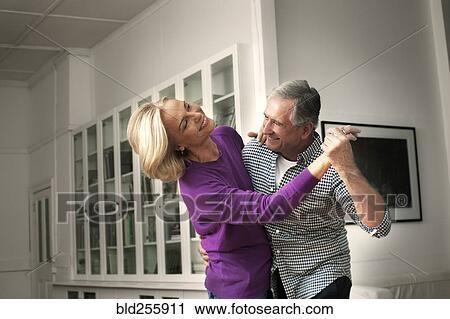 Smiling Caucasian couple dancing in home View Large Photo Image Stock Image - Smiling Caucasian couple dancing in home. Fotosearch