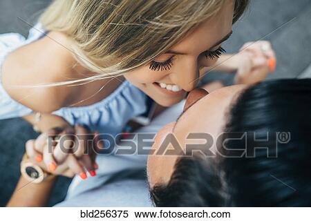 Stock Photography - Smiling Caucasian couple holding hands and rubbing noses. Fotosearch