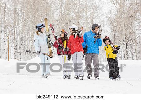 Stock Image - Smiling Caucasian family on skiing vacation. Fotosearch