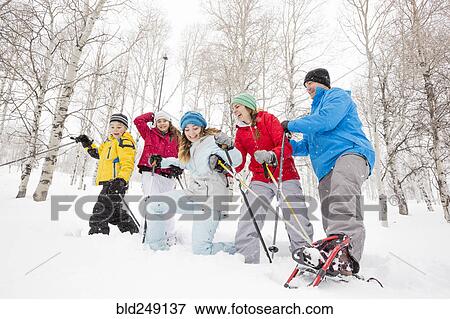 Smiling Caucasian family snowshoeing View Large Photo Image Stock Photo - Smiling Caucasian family snowshoeing. Fotosearch