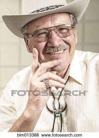 Smiling Caucasian man in cowboy hat View Large Photo Image Stock Photo - Smiling Caucasian man in cowboy hat. Fotosearch