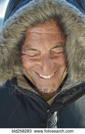 Smiling Caucasian man wearing coat with fur hood View Large Photo Image Stock Image - Smiling Caucasian man wearing coat with fur hood. Fotosearch