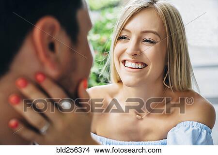 Picture - Smiling Caucasian woman embracing man. Fotosearch
