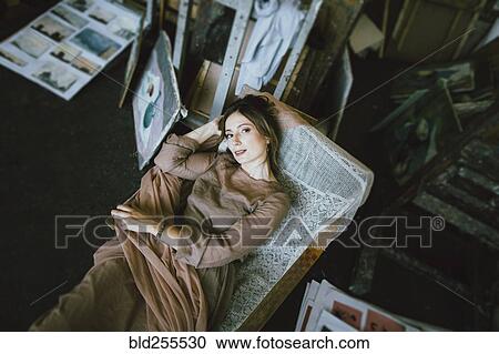 Smiling Caucasian woman laying on chaise longue View Large Photo Image Stock Image - Smiling Caucasian woman laying on chaise longue. Fotosearch