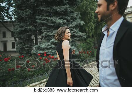 Stock Image - Smiling Caucasian woman looking at man. Fotosearch