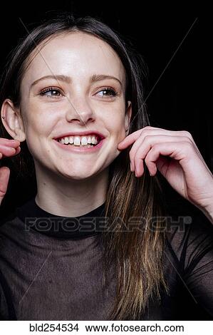 Picture - Smiling Caucasian woman pinching cheek. Fotosearch