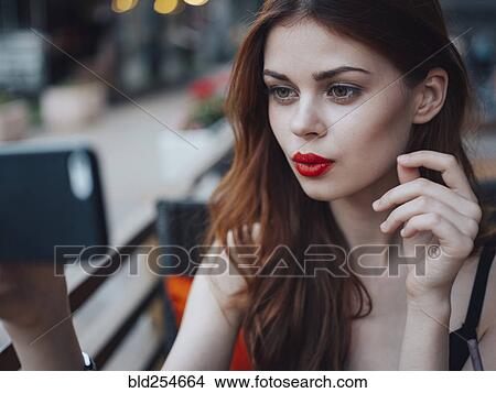Smiling Caucasian woman posing for cell phone selfie View Large Photo Image Picture - Smiling Caucasian woman posing for cell phone selfie. Fotosearch