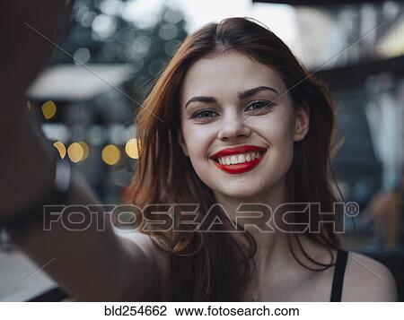 Smiling Caucasian woman posing for selfie View Large Photo Image Stock Image - Smiling Caucasian woman posing for selfie. Fotosearch