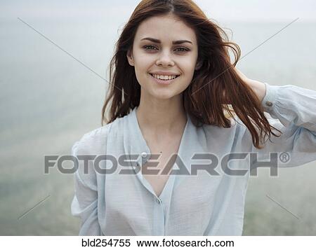 Smiling Caucasian woman standing near ocean View Large Photo Image Stock Photography - Smiling Caucasian woman standing near ocean. Fotosearch