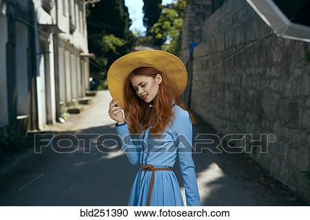 Smiling Caucasian woman wearing hat near stone wall View Large Photo Image Stock Image - Smiling Caucasian woman wearing hat near stone wall. Fotosearch
