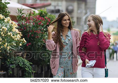 Smiling Caucasian women walking with hands in hair View Large Photo Image Stock Image - Smiling Caucasian women walking with hands in hair. Fotosearch