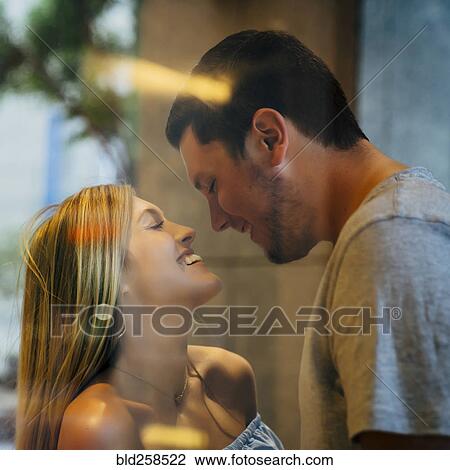 Smiling couple behind window View Large Photo Image Stock Image - Smiling couple behind window. Fotosearch