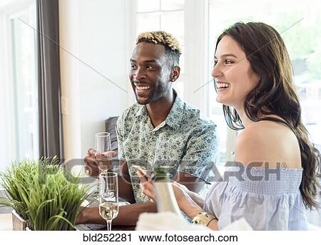 Stock Image - Smiling couple drinking champagne. Fotosearch