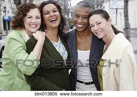 Stock Photography - Smiling friends standing together. Fotosearch