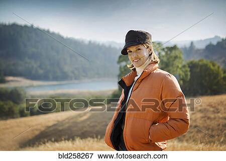 Smiling Hispanic woman wearing coat and hat outdoors View Large Photo Image Stock Photo - Smiling Hispanic woman wearing coat and hat outdoors. Fotosearch