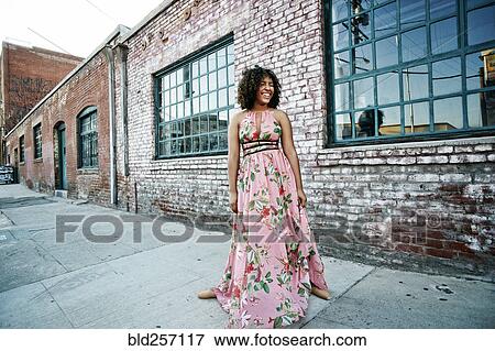 Smiling mixed race ballet dancer wearing dress on sidewalk View Large Photo Image Stock Photo - Smiling mixed race ballet dancer wearing dress on sidewalk. Fotosearch