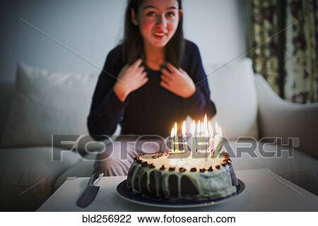 Smiling mixed race girl sitting near birthday cake View Large Photo Image Stock Image - Smiling mixed race girl sitting near birthday cake. Fotosearch