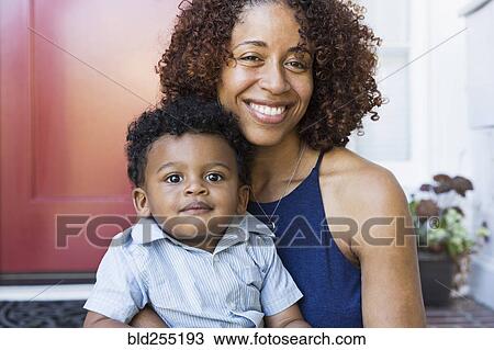 Smiling mixed race mother and baby son sitting on front stoop View Large Photo Image Stock Image - Smiling mixed race mother and baby son sitting on front stoop. Fotosearch