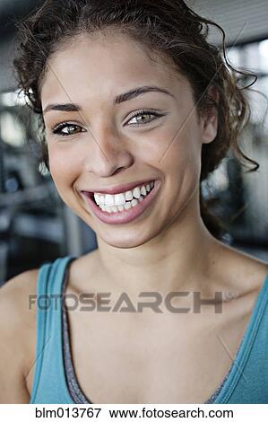 Stock Photo - Smiling mixed race woman in health club. Fotosearch