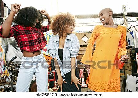 Smiling women dancing outdoors View Large Photo Image Stock Image - Smiling women dancing outdoors. Fotosearch