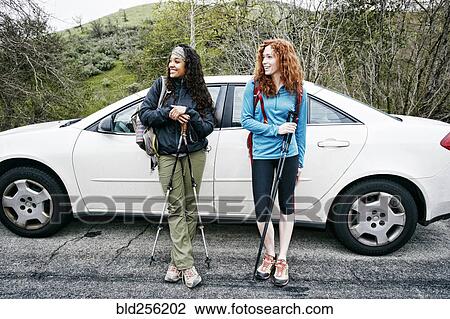 Smiling women standing near car hold and walking sticks View Large Photo Image Stock Image - Smiling women standing near car hold and walking sticks. Fotosearch