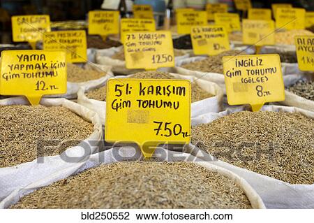 Stock Image - Spices in sacks with prices at market. Fotosearch
