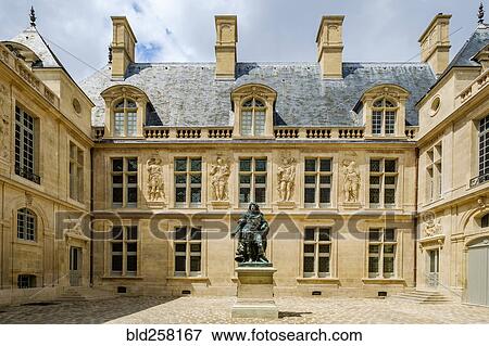 Statue in courtyard near building View Large Photo Image Stock Photo - Statue in courtyard near building. Fotosearch
