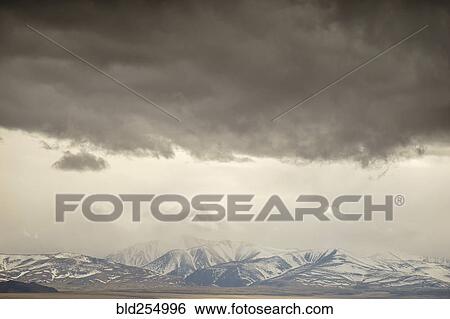 Storm clouds over mountain landscape View Large Photo Image Stock Photograph - Storm clouds over mountain landscape. Fotosearch