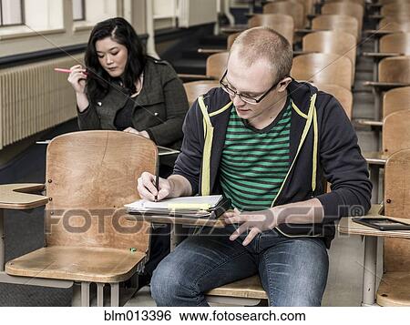 Stock Photograph - Students studying in classroom. Fotosearch