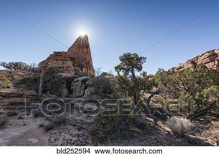 Picture - "Sun in blue sky over desert, Moab, Utah, United States". Fotosearch