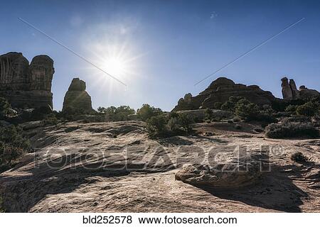 Stock Photo - "Sun in blue sky over desert, Moab, Utah, United States". Fotosearch