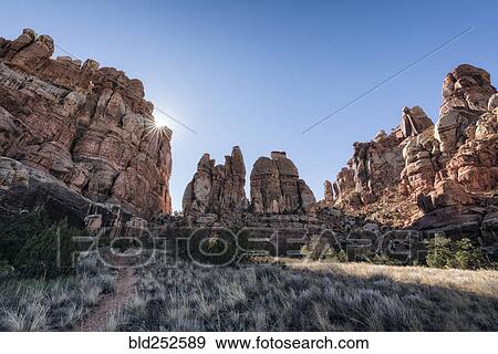 Stock Photo - "Sun in blue sky over desert, Moab, Utah, United States". Fotosearch